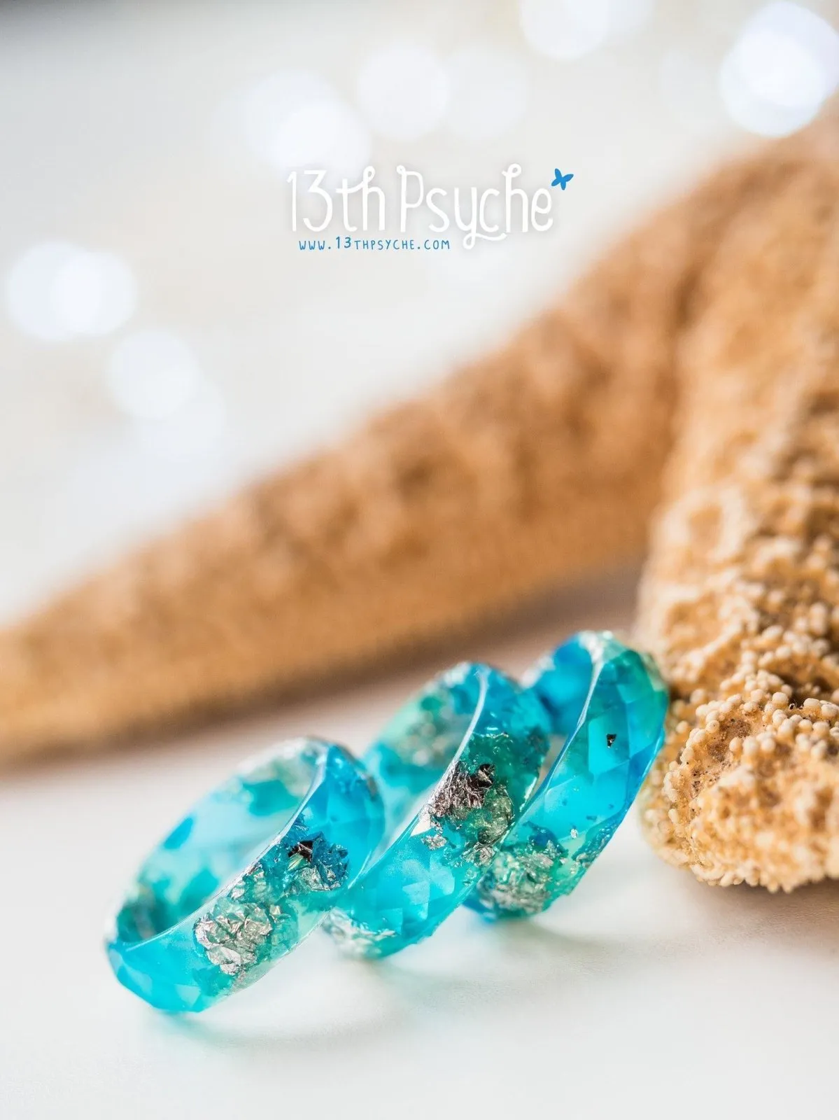 Clear blue and turquoise faceted resin ring with silver flakes